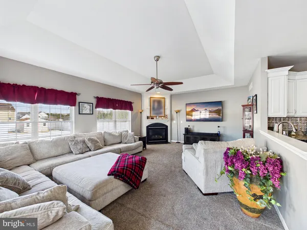 a living room with furniture fireplace and flat screen tv