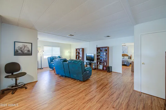 a living room with furniture and a wooden floor