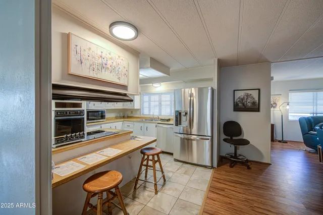 a view of a kitchen with dining table and chairs