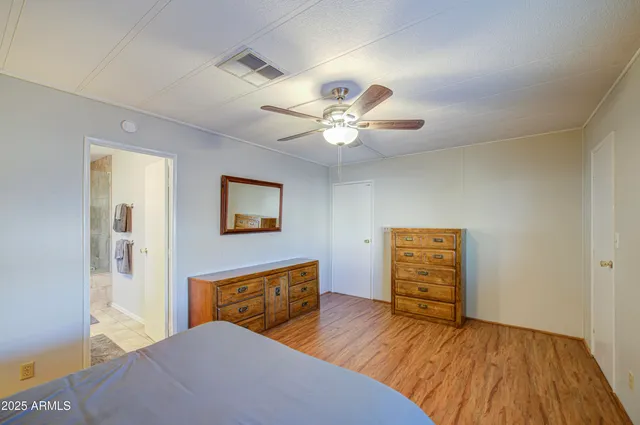 a bedroom with furniture and a chandelier