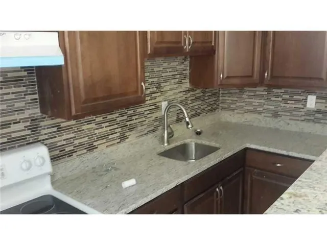 a kitchen with a sink and cabinets
