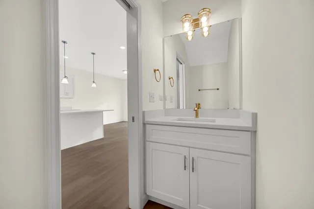 a bathroom with a sink a mirror and a shower