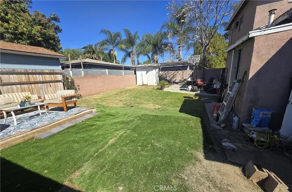 a view of a backyard with plants and a patio