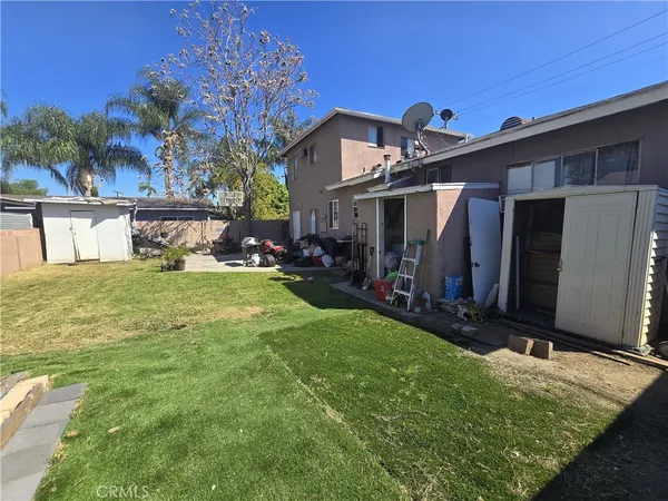 a view of a house with backyard porch and sitting area