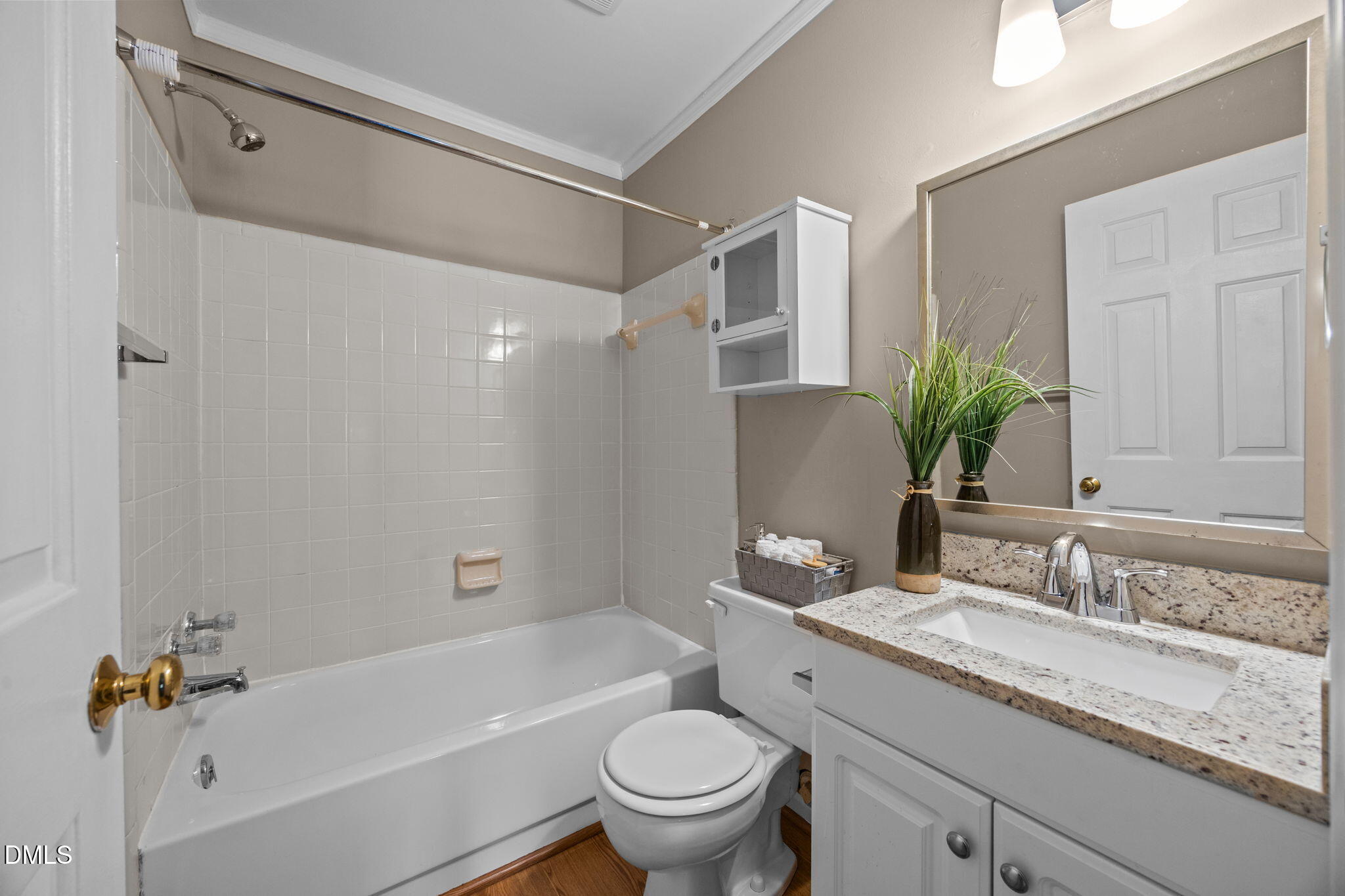 1524 Township Circle Raleigh, NC 27609 - Photo 16 of 30 a bathroom with a granite countertop sink a toilet a mirror a vanity a bathtub and shower