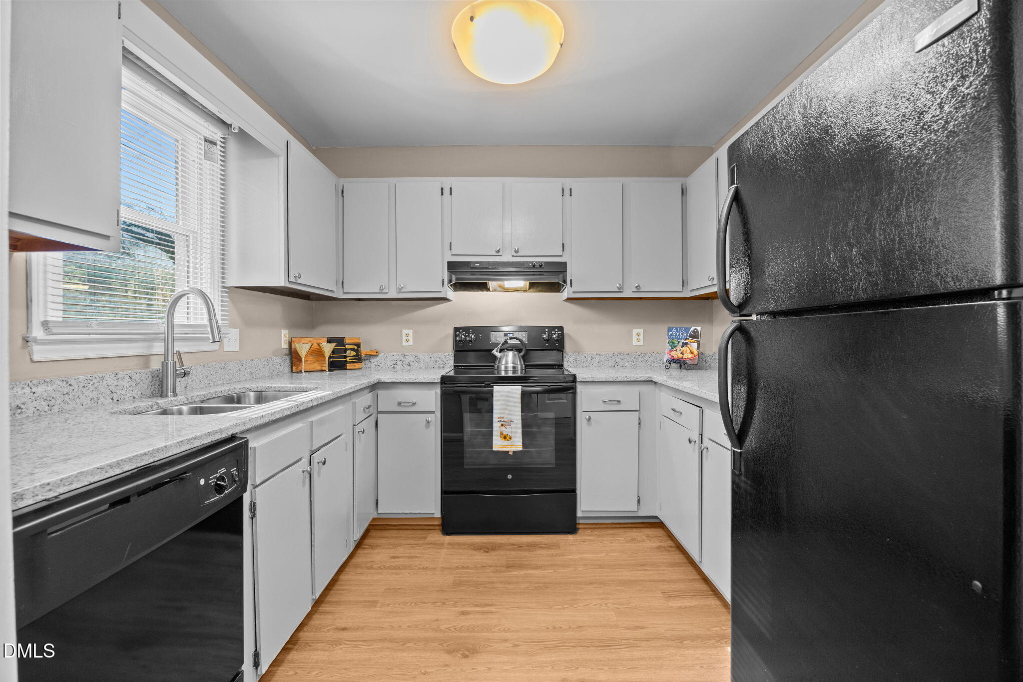 1524 Township Circle Raleigh, NC 27609 - Photo 4 of 30 a kitchen with a refrigerator sink and cabinets
