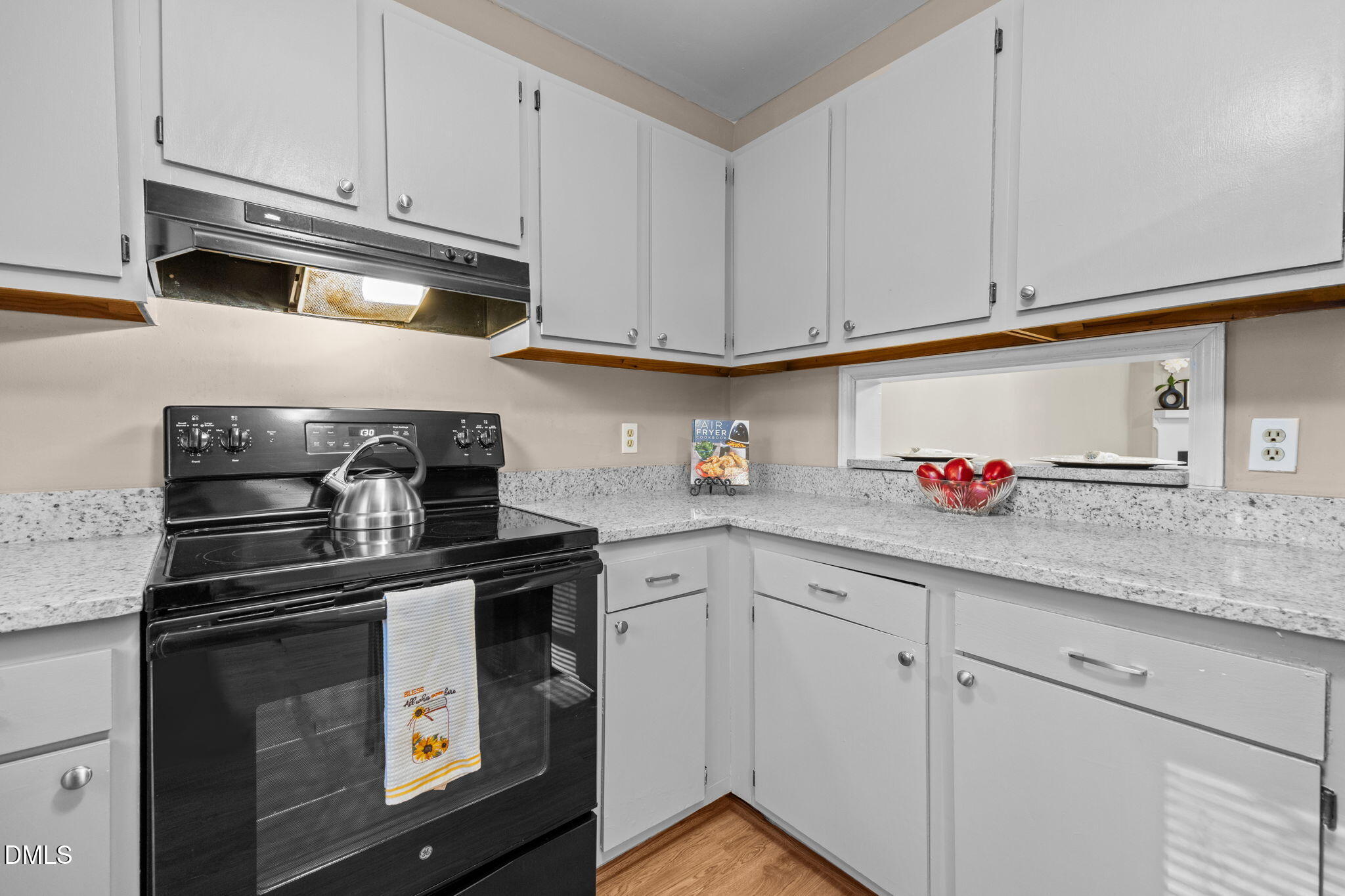 1524 Township Circle Raleigh, NC 27609 - Photo 5 of 30 a kitchen with granite countertop white cabinets and stainless steel appliances