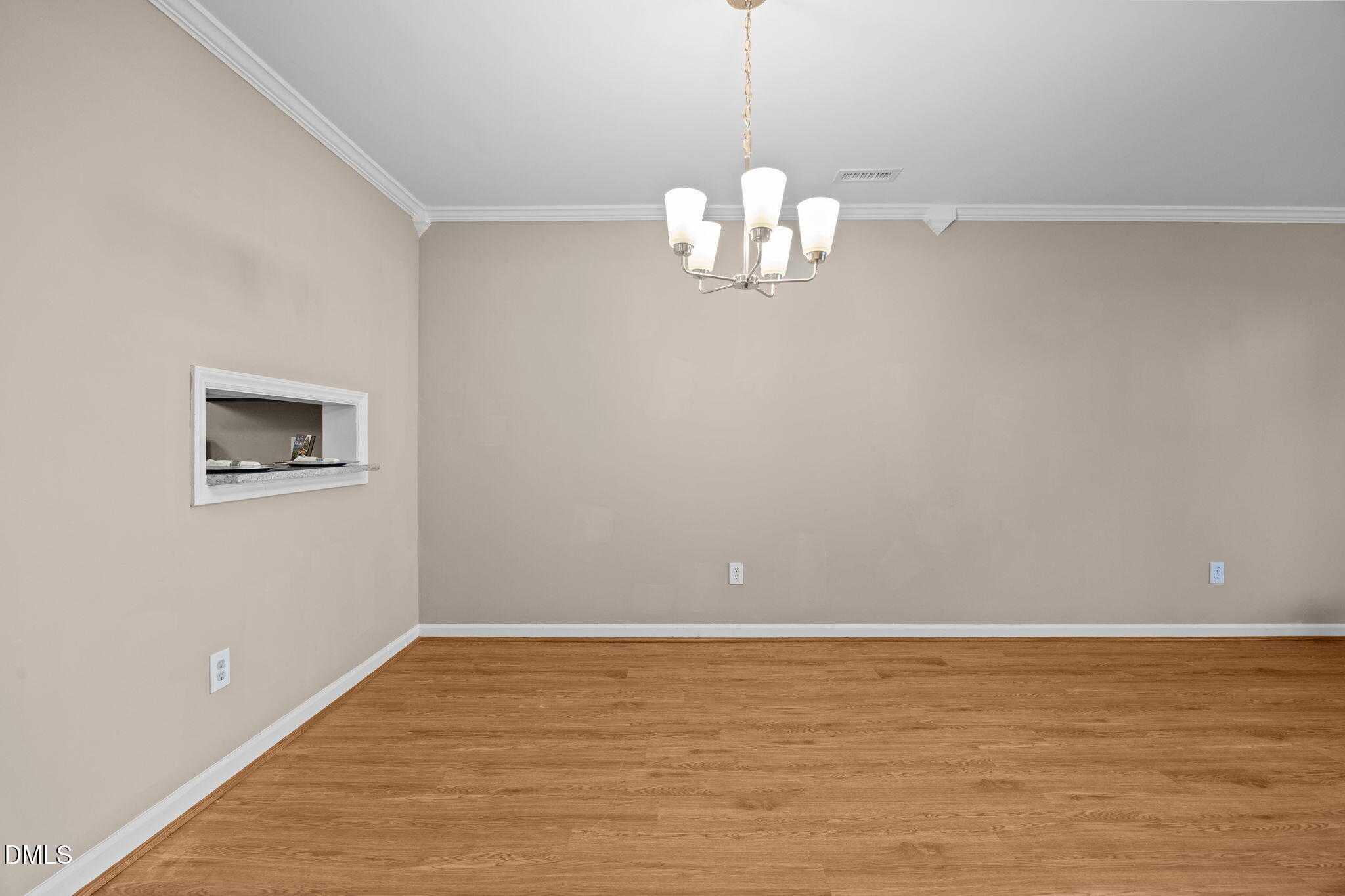 1524 Township Circle Raleigh, NC 27609 - Photo 7 of 30 a view of an empty room with wooden floor and chandelier