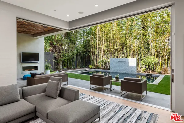 a living room with furniture tv and a large window