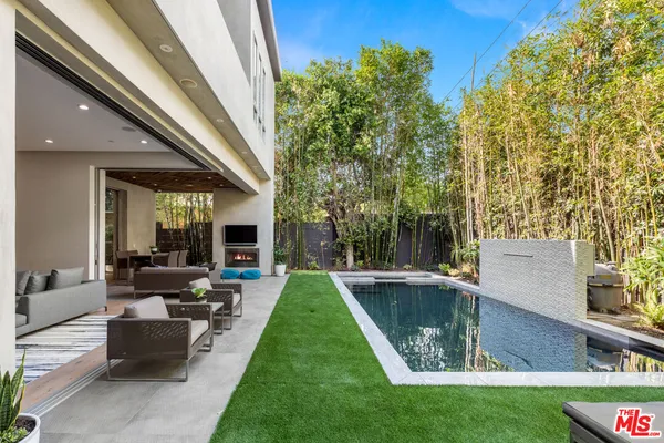 a view of a house with swimming pool and sitting area