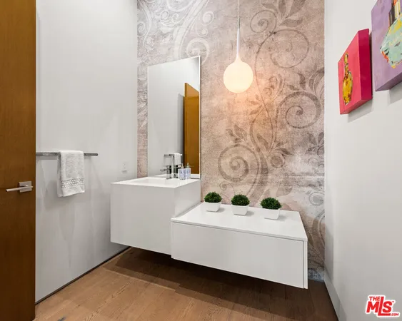 a bathroom with a tub sink and mirror