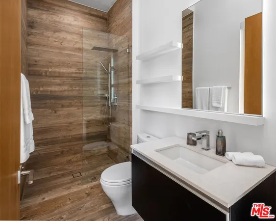 a bathroom with a toilet sink and shower