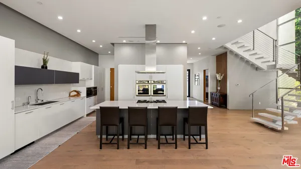 a large kitchen with a table and chairs