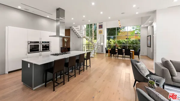 a large kitchen with a table and chairs