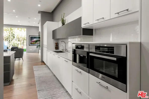 a kitchen with stainless steel appliances kitchen island granite countertop a stove a sink and a microwave