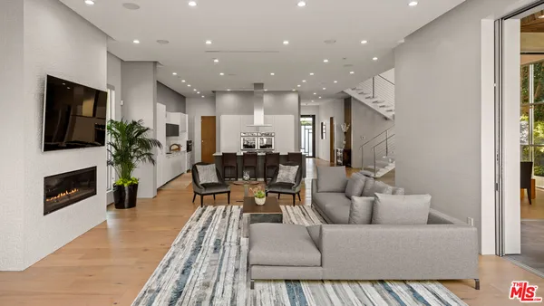 a living room with furniture fireplace and flat screen tv