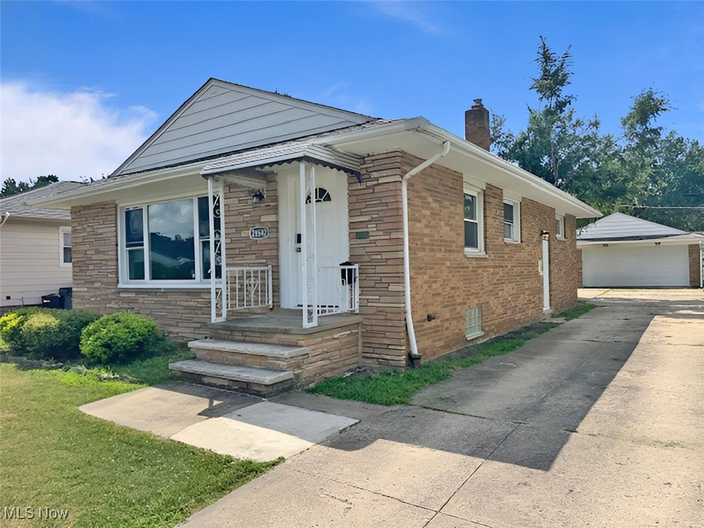Brick ranch style home with detached two car garage