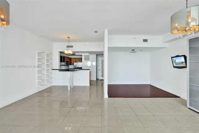a view of kitchen with refrigerator and microwave