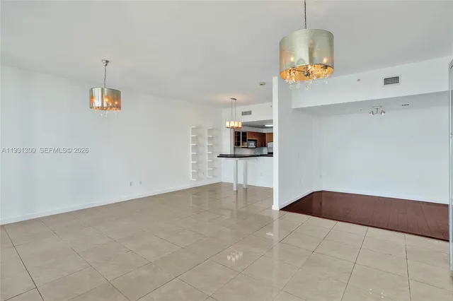 a living room with a couch and chandelier