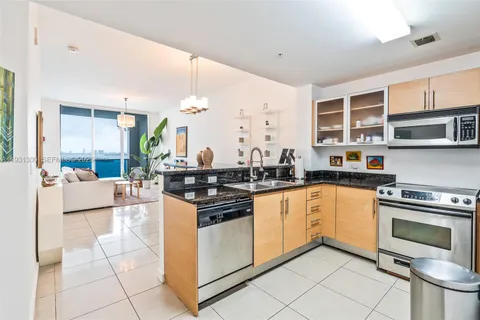 a kitchen with stainless steel appliances granite countertop a stove and a sink