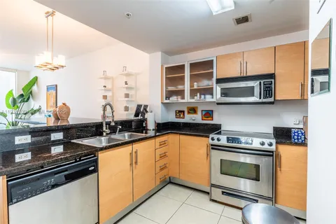 a kitchen with stainless steel appliances a stove sink and cabinets