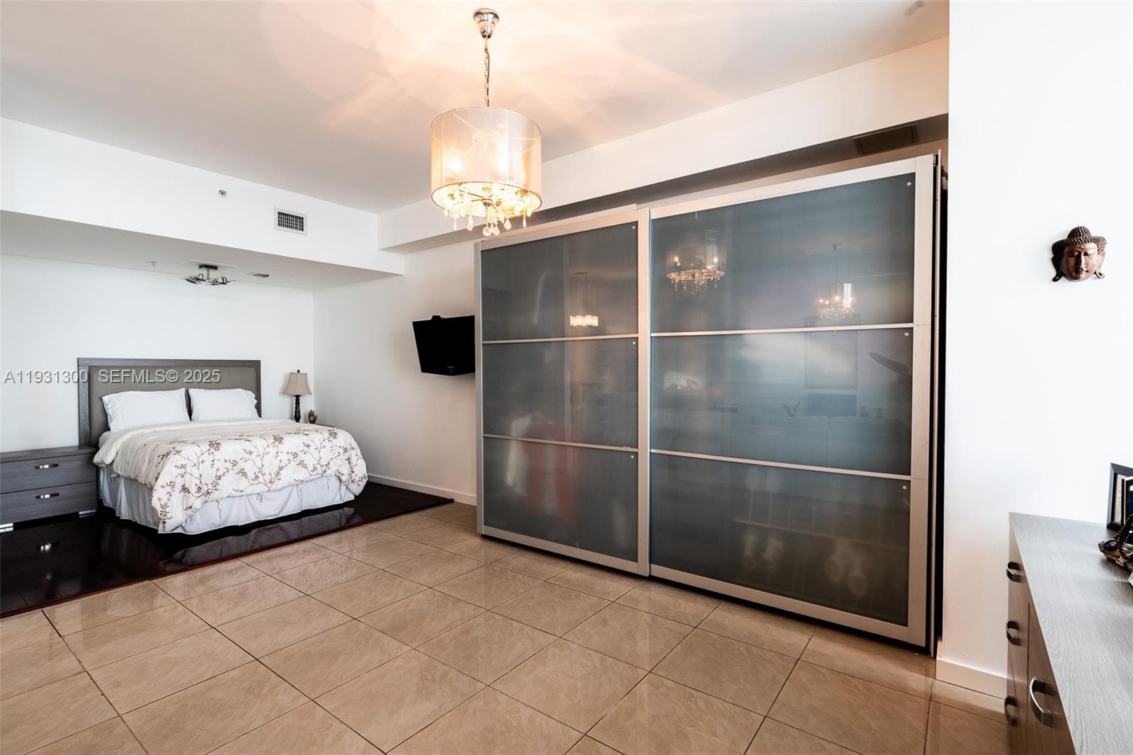 725 Northeast 22nd Street, Unit 9E Miami, FL 33137 - Photo 8 of 12 a bedroom with a bed and a mirror