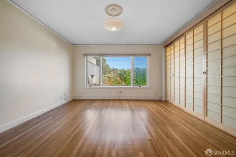 a bedroom with a large bed and a large window