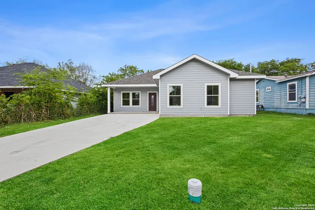 a front view of house with yard and green space