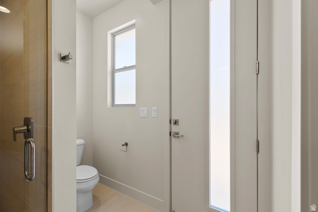 2955 East Rimrunner Drive St. George, UT 84790 - Photo 21 of 35 Powder room featuring a white toilet, light-toned floor tiling, and a rectangular window