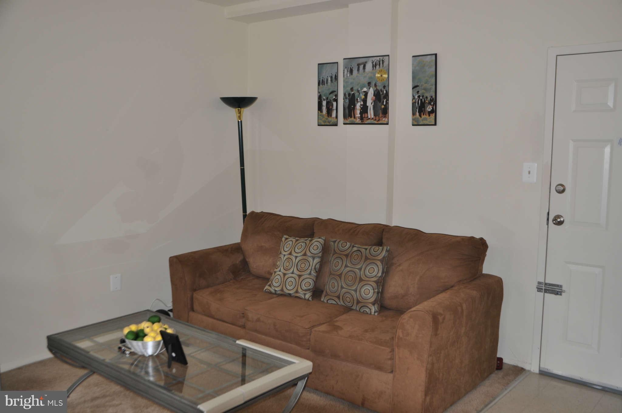 1440 W Street Northwest, Unit 406 Washington, DC 20009 - Photo 2 of 12 a living room with furniture