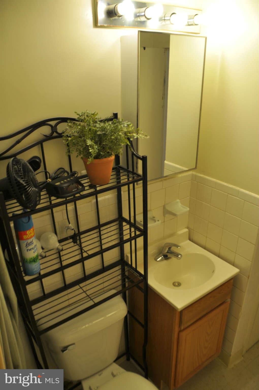 1440 W Street Northwest, Unit 406 Washington, DC 20009 - Photo 5 of 12 a bathroom with a sink and mirror