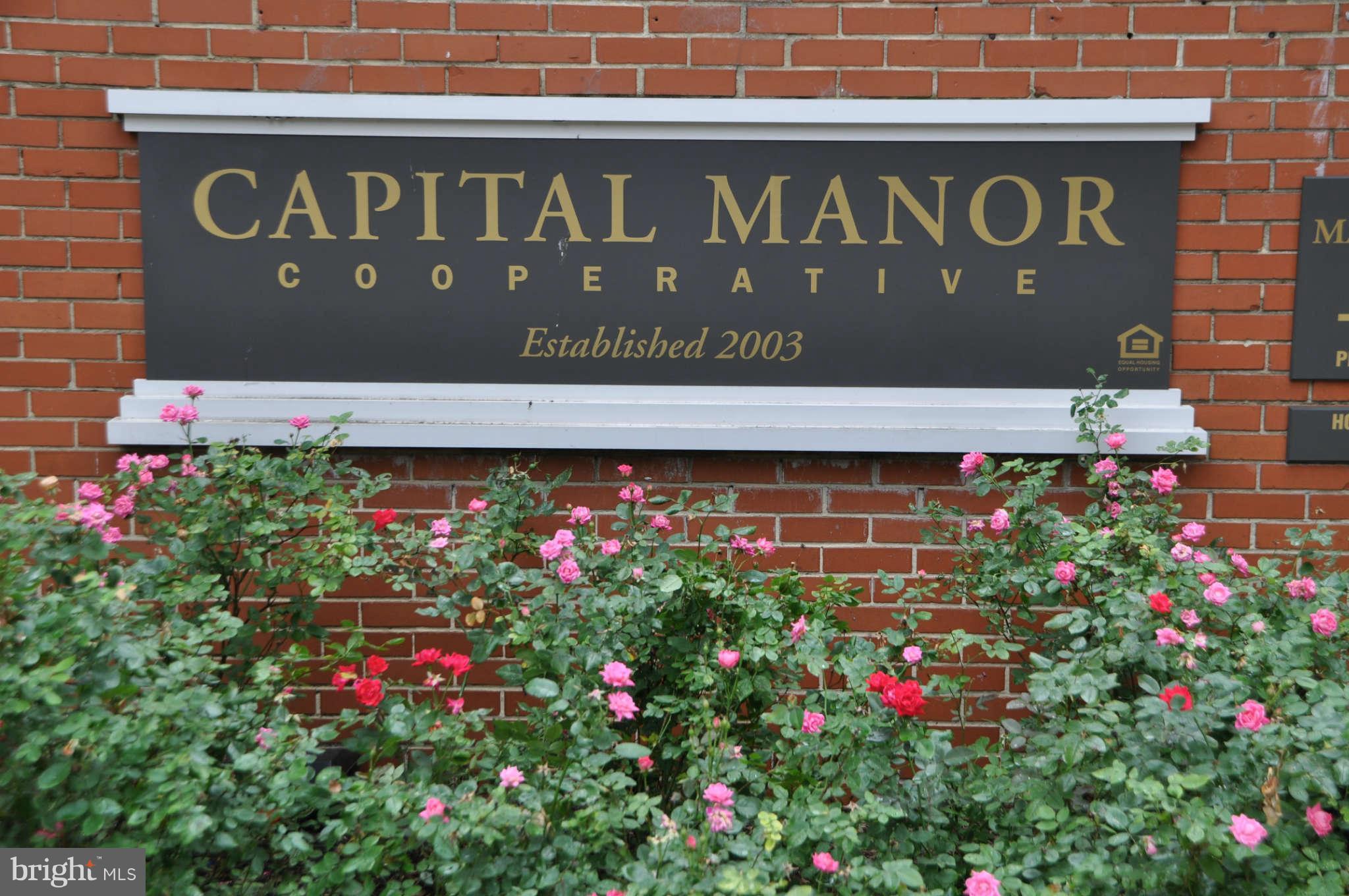 1440 W Street Northwest, Unit 406 Washington, DC 20009 - Photo 6 of 12 a sign that is in front of flowers