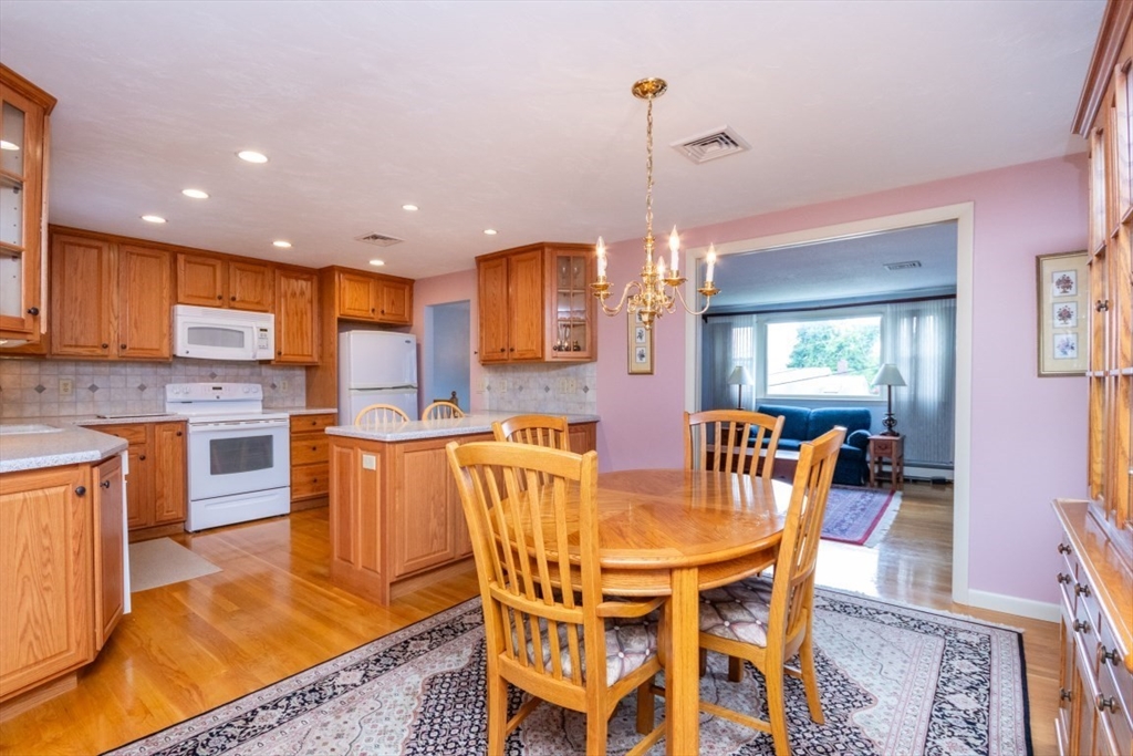 35 Gardiner Road Quincy, MA 02169 - Photo 10 of 35 a view of a dining room and livingroom with furniture wooden floor a chandelier