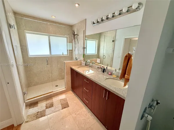 a bathroom with a tub sink and mirror
