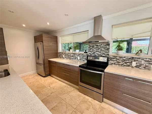a kitchen with stainless steel appliances a stove and a refrigerator