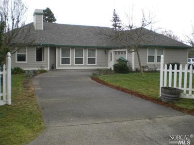 7059 Lynch Road Sebastopol, CA 95472 - Photo 1 of 1 a front view of a house with a garden