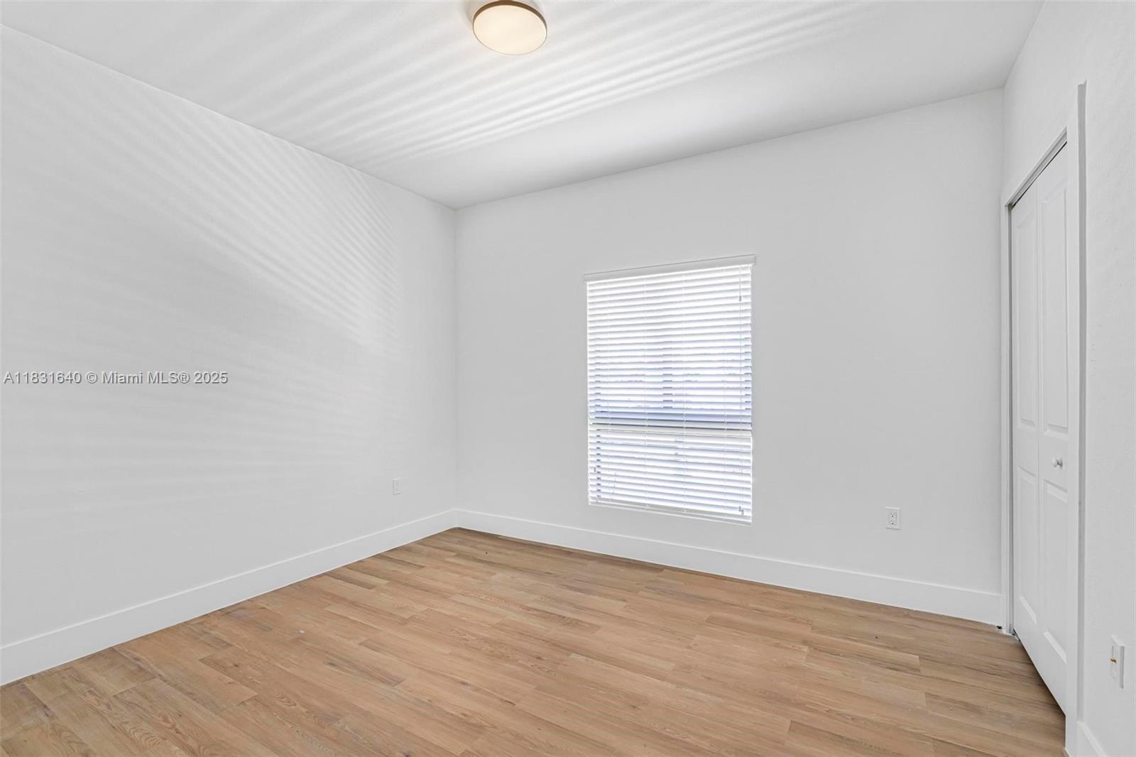 16955 Southwest 100th Avenue Miami, FL 33157 - Photo 27 of 42 an empty room with wooden floor and windows