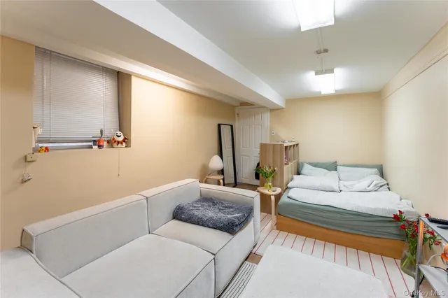 a bedroom with a large bed and window