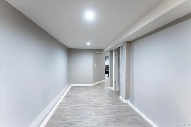 a view of hallway with wooden floor