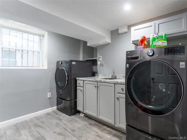 a utility room with sink dryer and washer