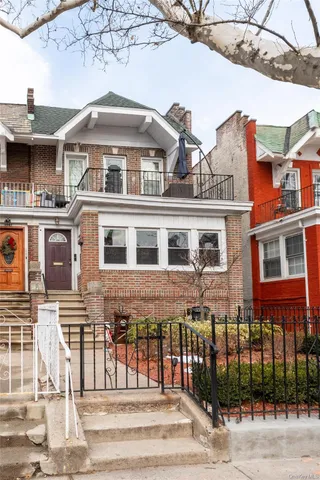 a front view of a building with a garden