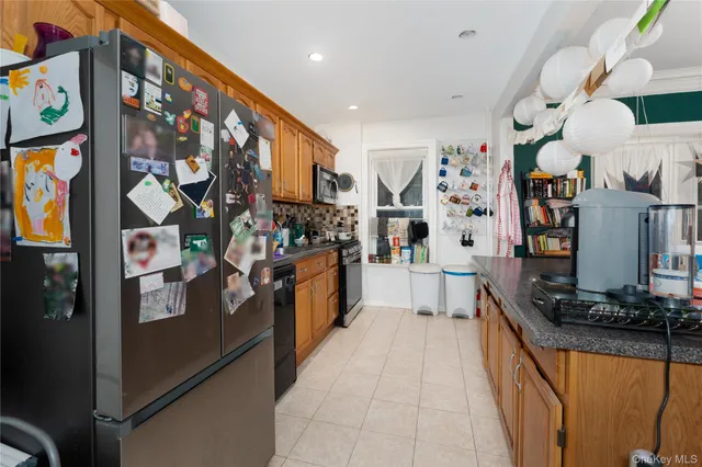 a kitchen with stainless steel appliances granite countertop a refrigerator and a stove