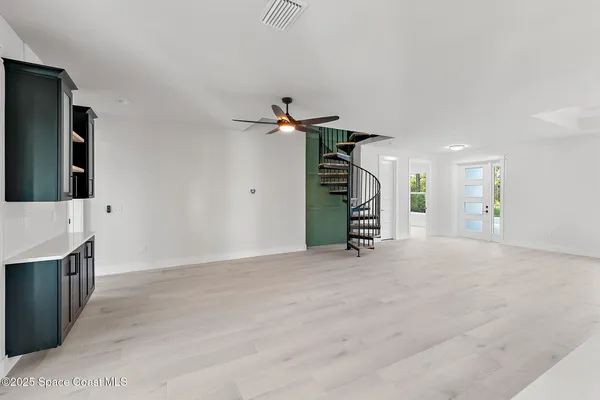a kitchen with stainless steel appliances kitchen island granite countertop a sink a stove and a refrigerator