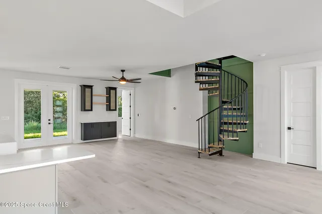 a kitchen with stainless steel appliances granite countertop a sink dishwasher a refrigerator and a stove with wooden floor