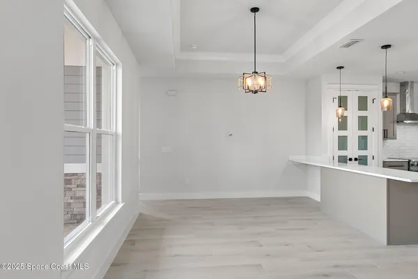 a kitchen with stainless steel appliances a stove a sink a center island and a window