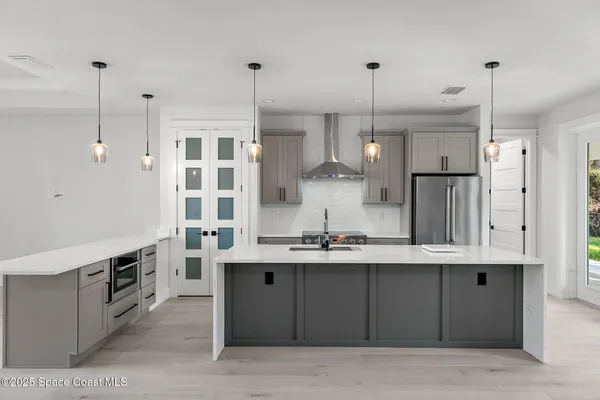 an empty room with a cabinet and mirrors