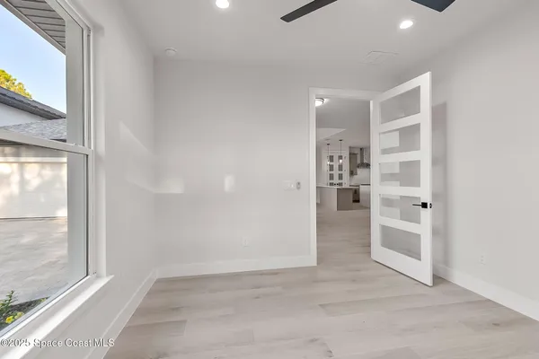 a white bath tub sitting next to a shower