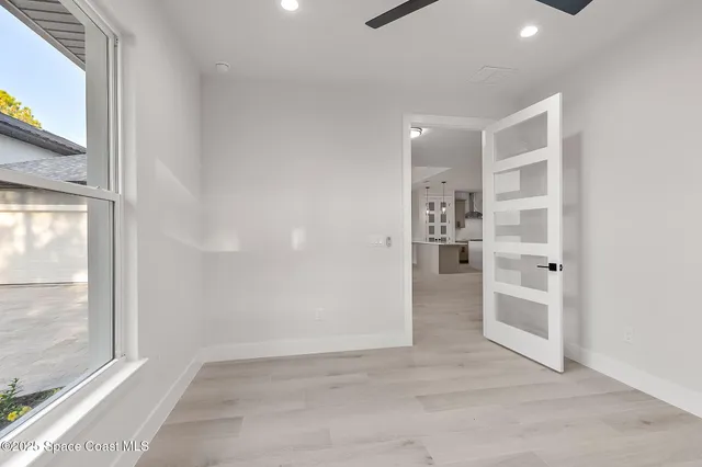 a white bath tub sitting next to a shower