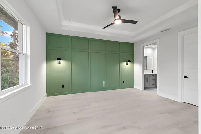 a view of a kitchen with white cabinets