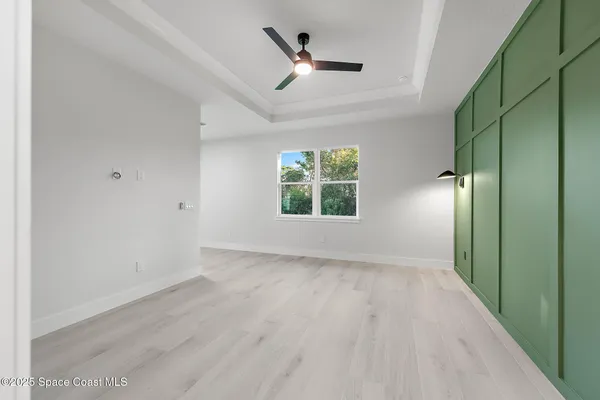 a kitchen with white cabinets a sink and stainless steel appliances